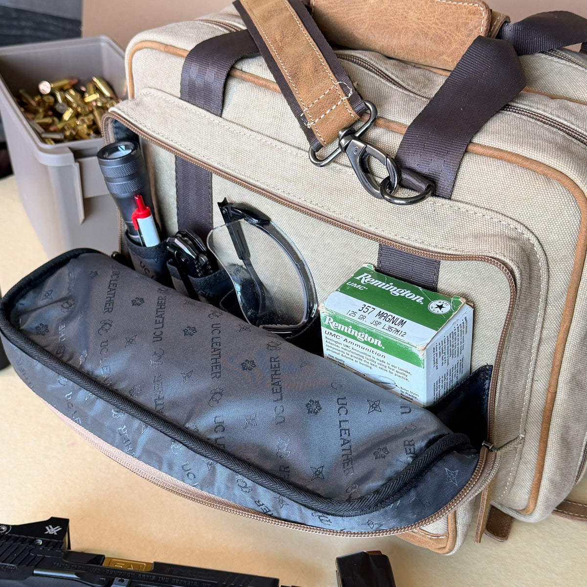 Open front zipper pocket of the UC Leather Small Range Bag with four organizer pockets