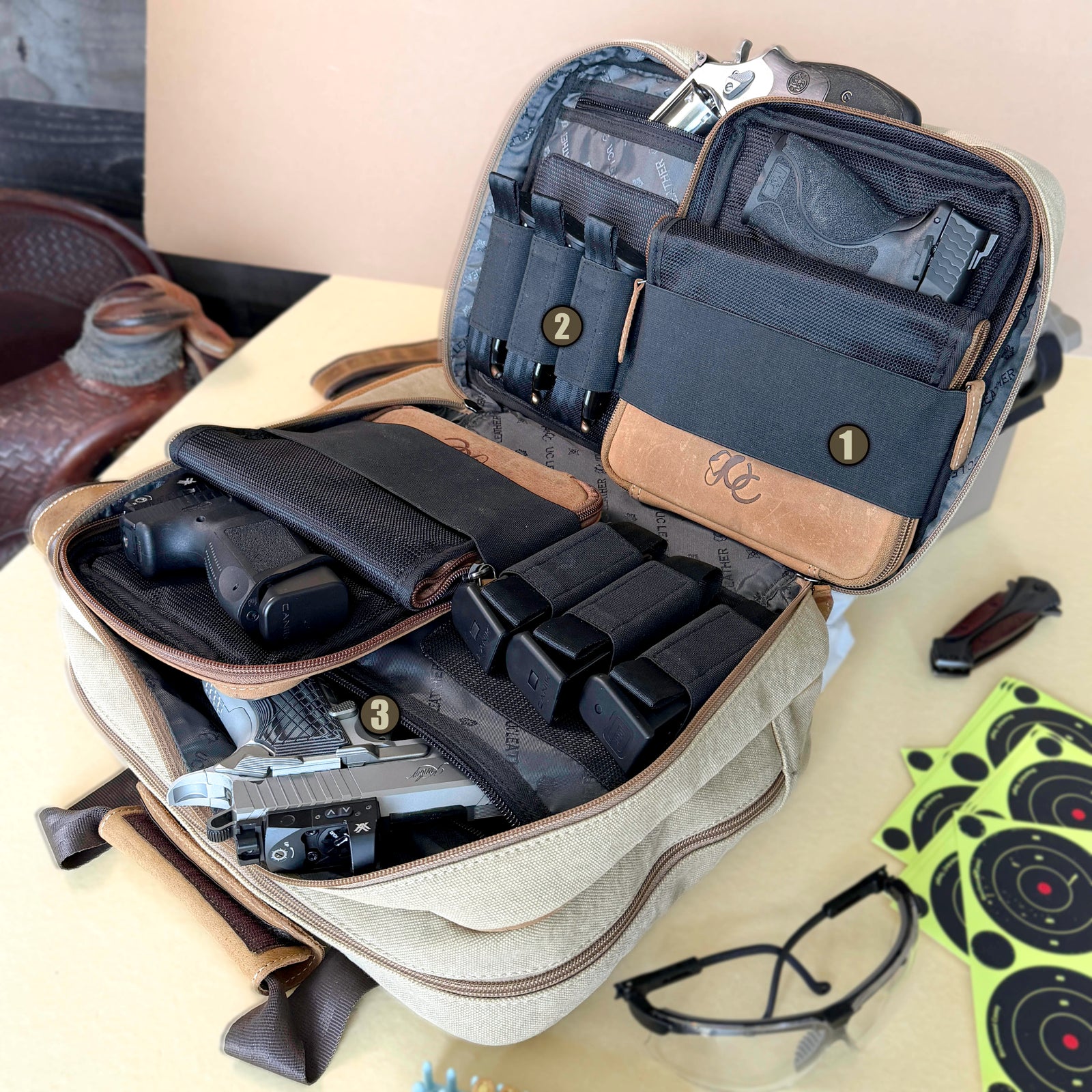 Open UC Leather Small Range Bag showing pistol case straps, six magazine slots, and two padded handgun pockets